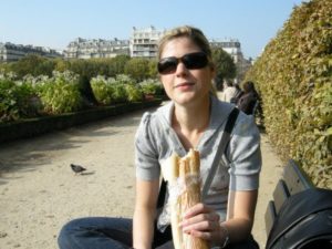 Katie Bartel, RD, diabetes dietitian, eats a baguette in Paris