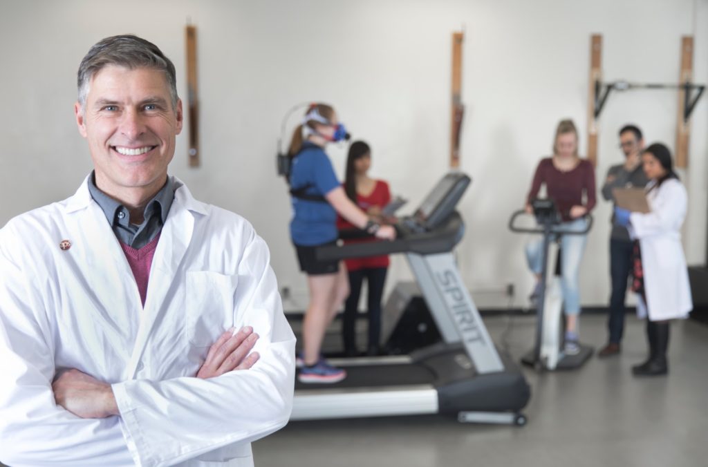 Dr. Michael Riddell stands in the foreground of his research participants in his lab focusing on T1D and exercise research