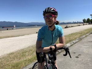 Girl on bike in the forefront of the Pacific Ocean pondering the challenges of type-1 diabetes and exercise