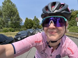 Female cyclist with T1D takes a selfie while riding bike